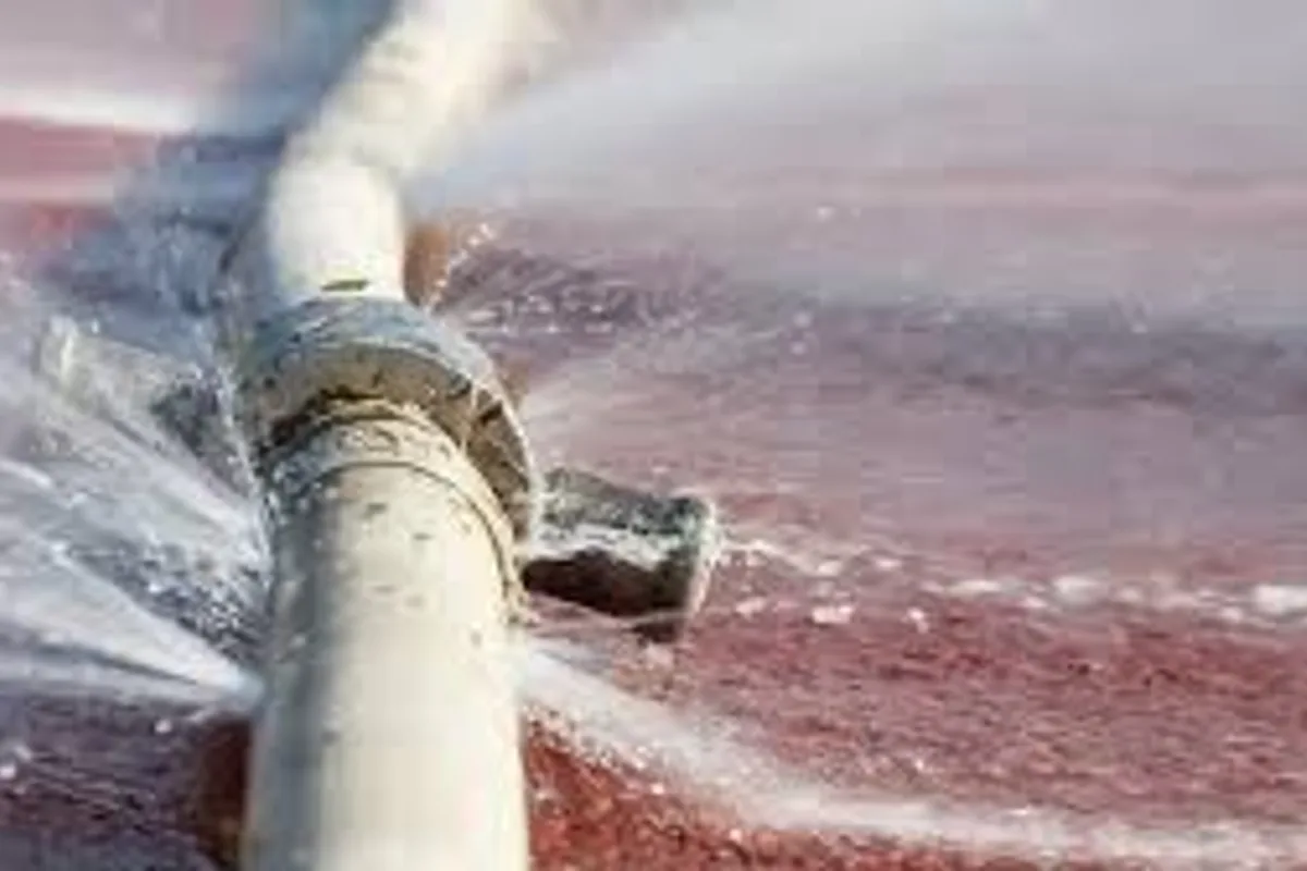 Plumber repairing a leaking water pipe