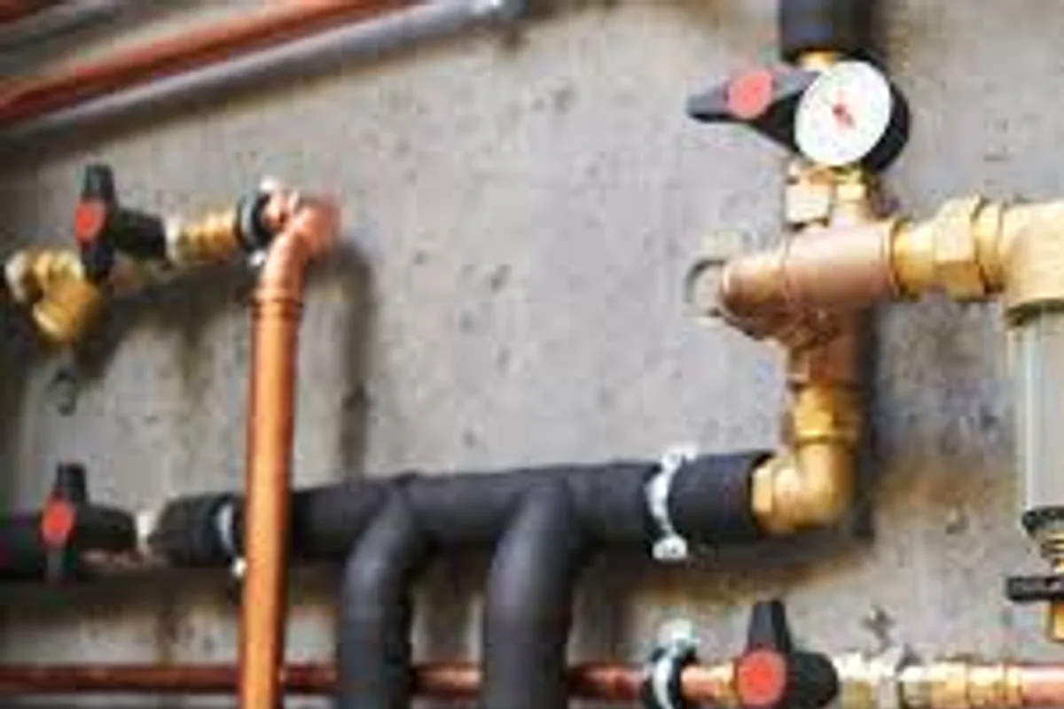 Plumber replacing old water pipes in a home